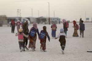 Adolescent girls leave a UNICEF -supported learning centre after their self-learning classes in Mahmoudli camp, Ar-Raqqa, northeast Syria, on 15 December 2021. They have, together with more than 8,000 people, sought shelter there.