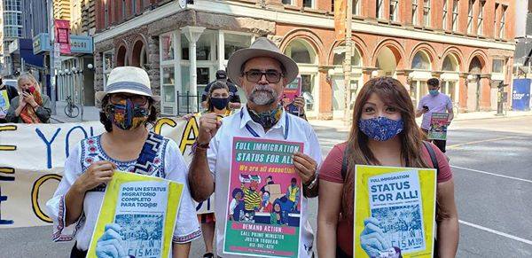 Members of the Migrant Rights Network protest in favour of “Status for All!” in Toronto, Canada in August, 2020. Provided to the author with permission.