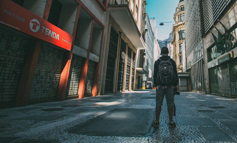 a man standing in the middle of an empty street in an urban area